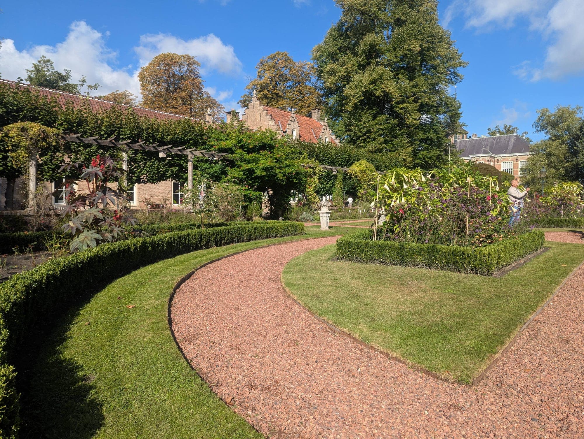 A curved garden path disappearing round a hedge, a route to something you cannot see yet.