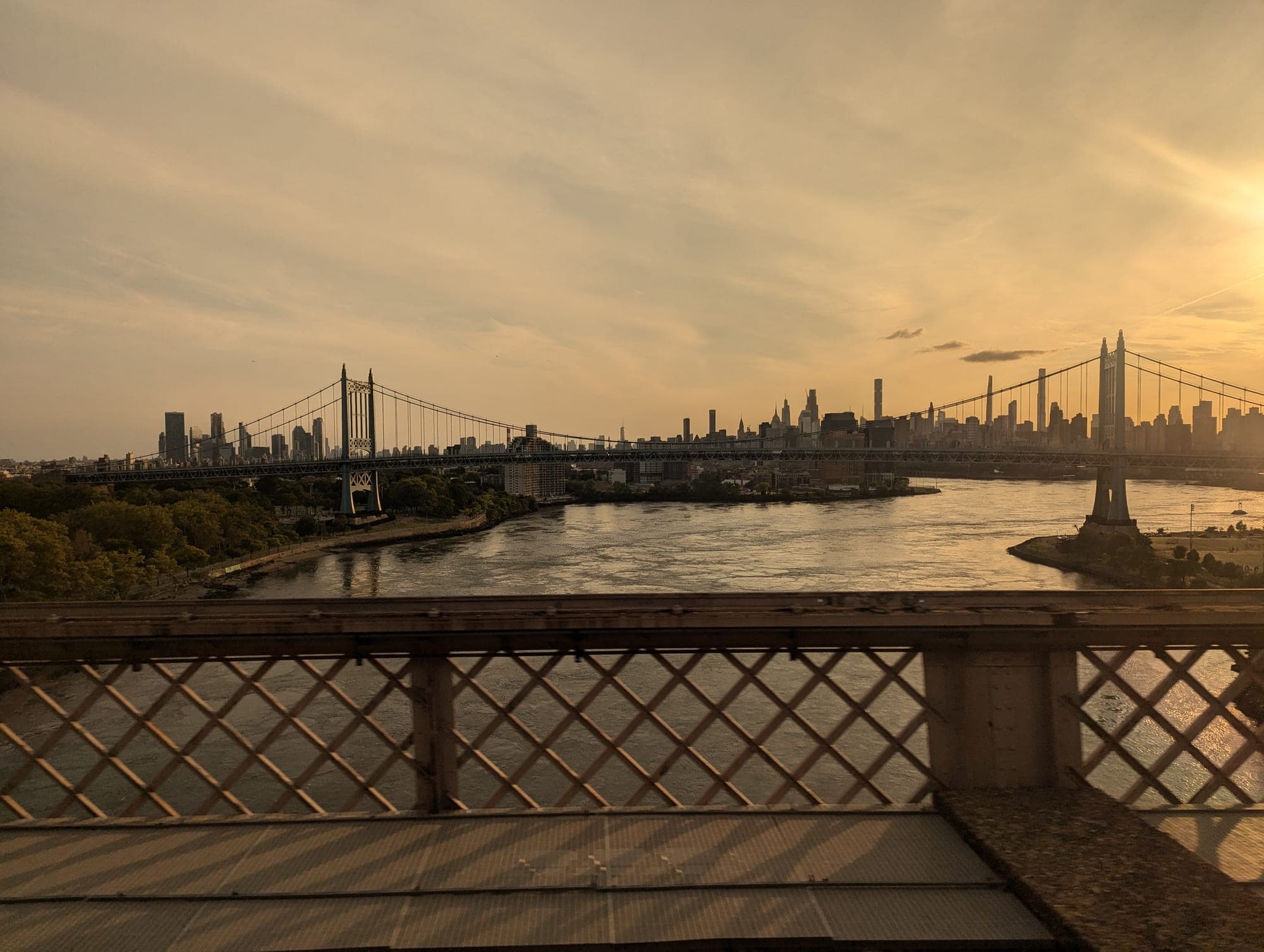 A bridge into a city at dusk, the crossing between a physical card and a phone.